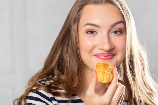 Beautiful smiling young woman with a cake