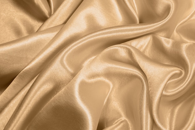 写真 抽象的な背景として美しい滑らかでエレガントな金色のシルクやサテンの質感を使用できます。布の色