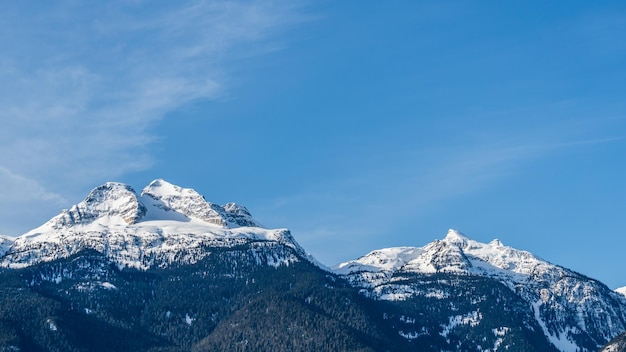 Beautiful snowcapped Columbia Mountains against the blue sky in British Columbia Canada