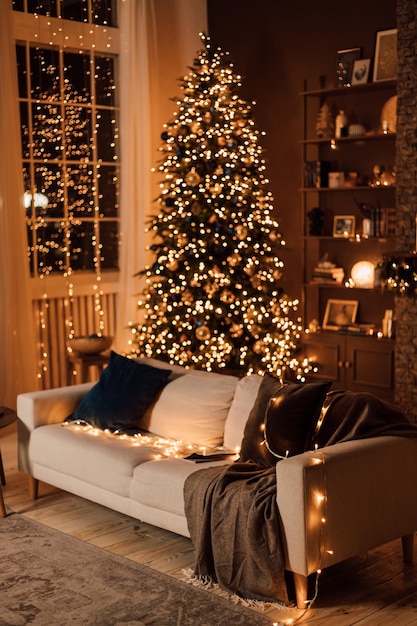 A beautiful soft light sofa with pillows stands in the living room near the Christmas tree