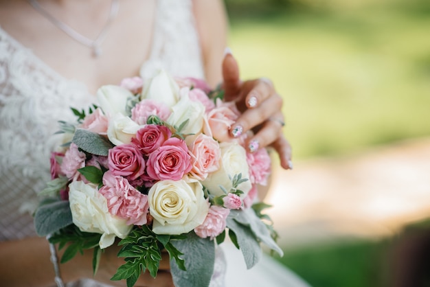 Beautiful and sophisticated wedding bouquet close-up holds the bride in her hands. Wedding bouquet.