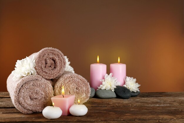 Beautiful spa composition with chrysanthemums on brown background