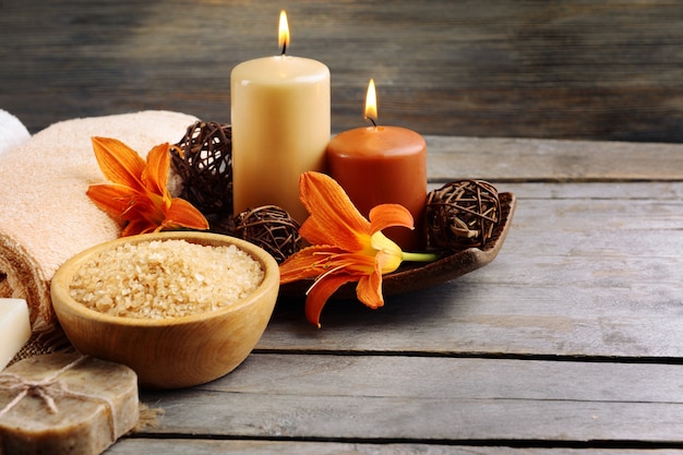 Beautiful spa composition with flowers on wooden table close up