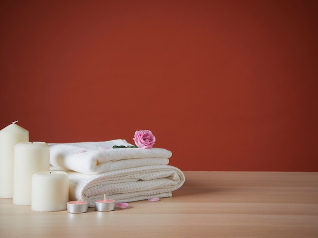 Beautiful spa composition with scented candles and roses on table