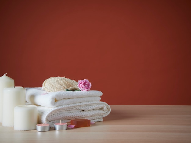 Beautiful spa composition with scented candles and roses on table