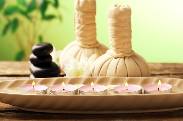 Beautiful spa composition on wooden table on green background