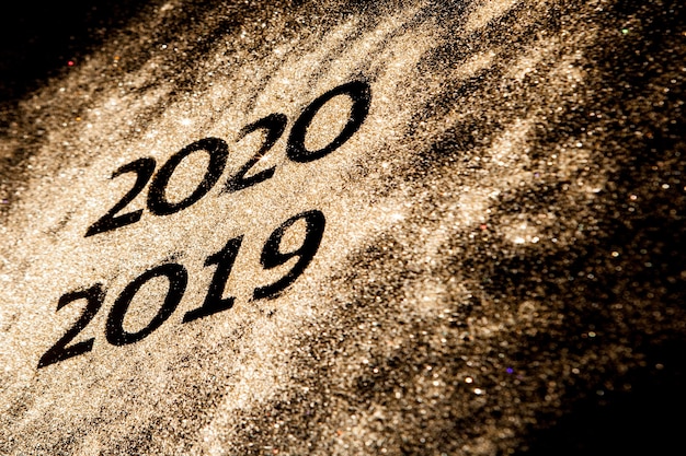 Beautiful sparkling Golden Numbers of 2019 to 2020 on black background for design