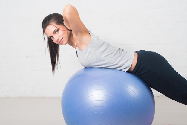 Beautiful sport woman doing fitness exercise on ball Pilates healthy back sports health