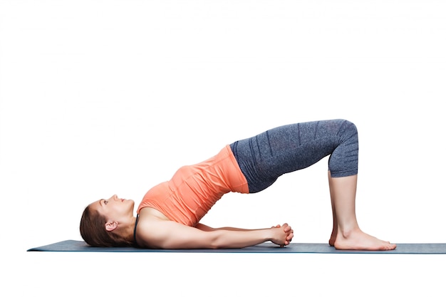beautiful sporty fit yogi girl practices yoga asana setu bandhas