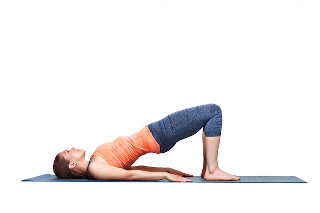 beautiful sporty fit yogi girl practices yoga asana setu bandhasana