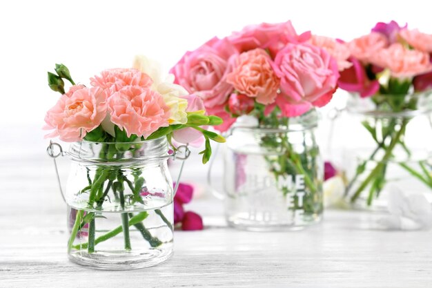 Beautiful spring flowers in glass bottles