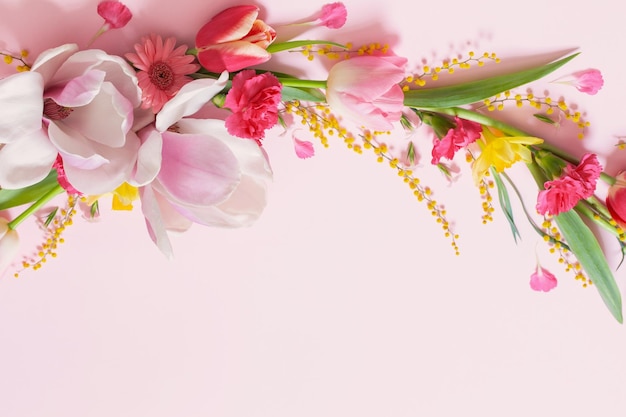 Beautiful spring flowers on pink background