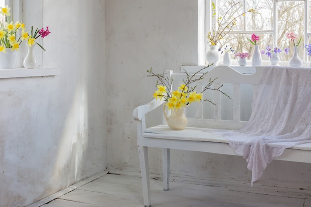 Beautiful spring flowers in white vintage interior