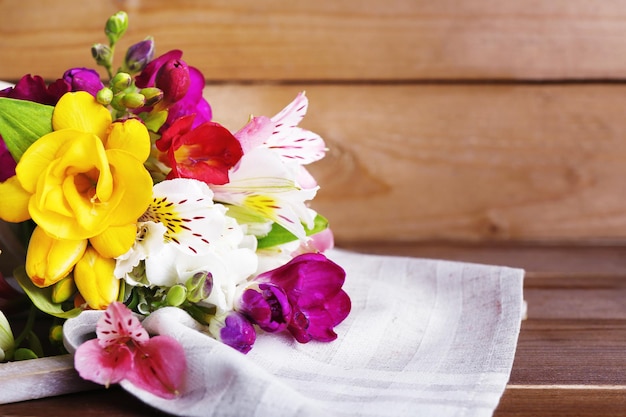 Beautiful spring flowers on wooden background