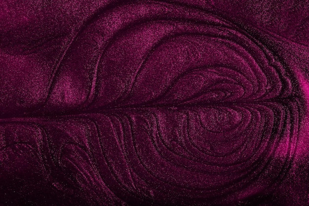 Beautiful stains of liquid nail polishfluid art techniqueDeep purple marble background