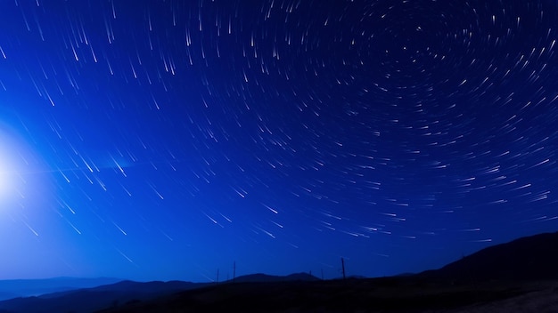 Beautiful star trails in dark blue sky night clear weather with starry day Starry sky time lapse with the star trails like comets 8K