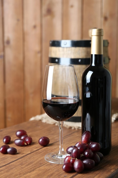 Beautiful still life with wine and grape on wooden table