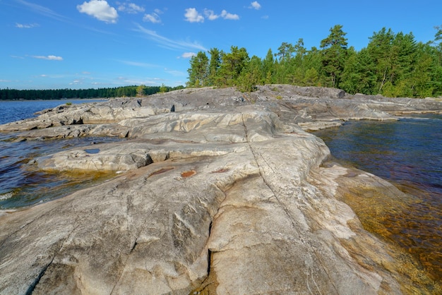 Beautiful stones and pine trees on the lake Landscape of wild nature