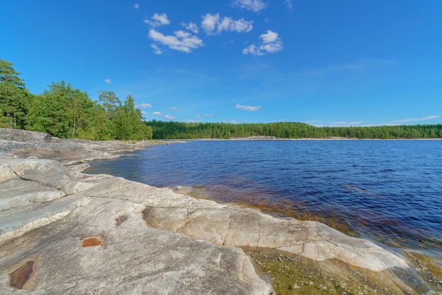 Beautiful stones and pine trees on the lake Landscape of wild nature