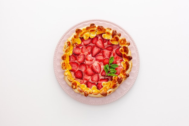 Beautiful strawberry gift pie on a plate with a spatula