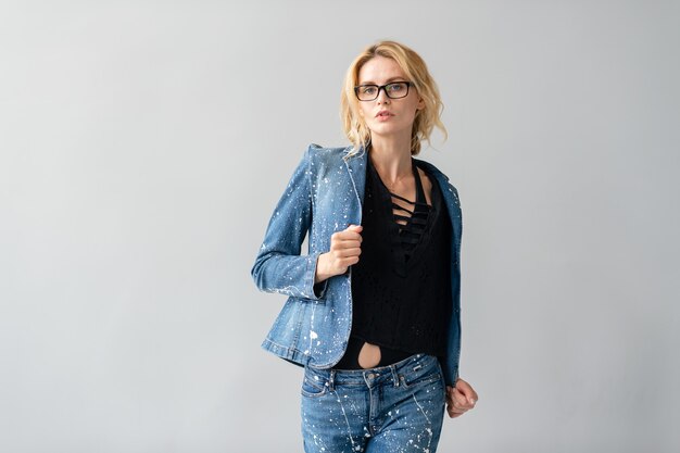 Beautiful stylish blonde model in jeans suit posing  