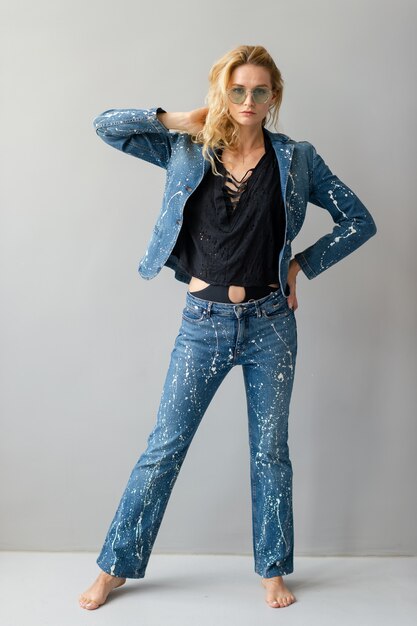 Beautiful stylish blonde model in jeans suit posing  