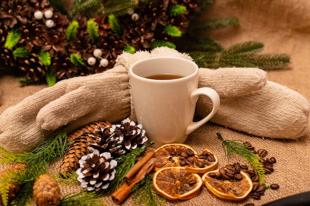 Beautiful stylish christmas composition with a cup of tea cinnamon and pine cones