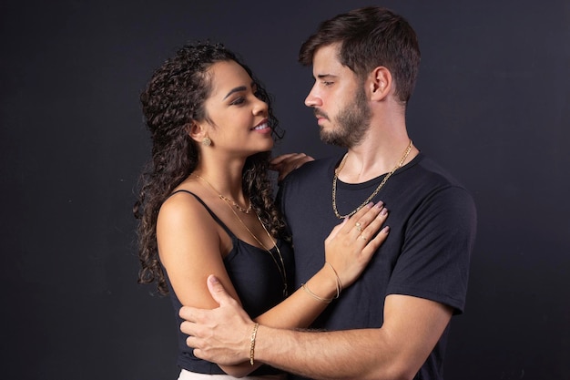 Beautiful stylish couple young man and woman in the studio on a black background