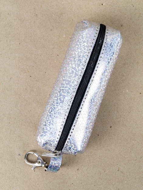 A beautiful and stylish key holder lies on a paper background Closeup photo