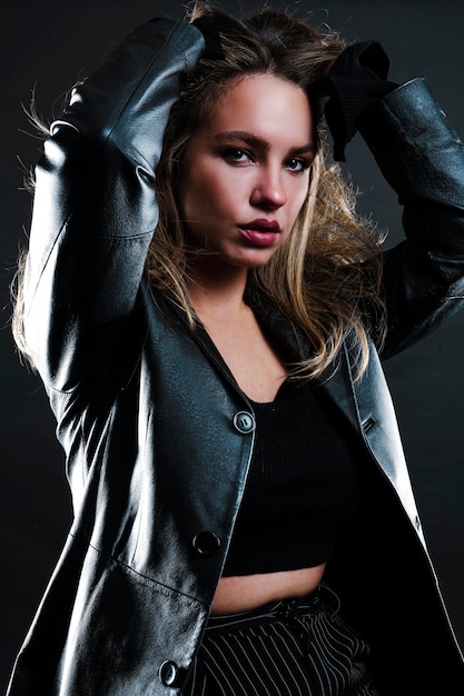 Beautiful stylish woman dressed in a black leather jacket.\
fashionable and self-confident girl