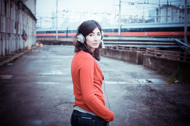 Beautiful stylish woman listening to music