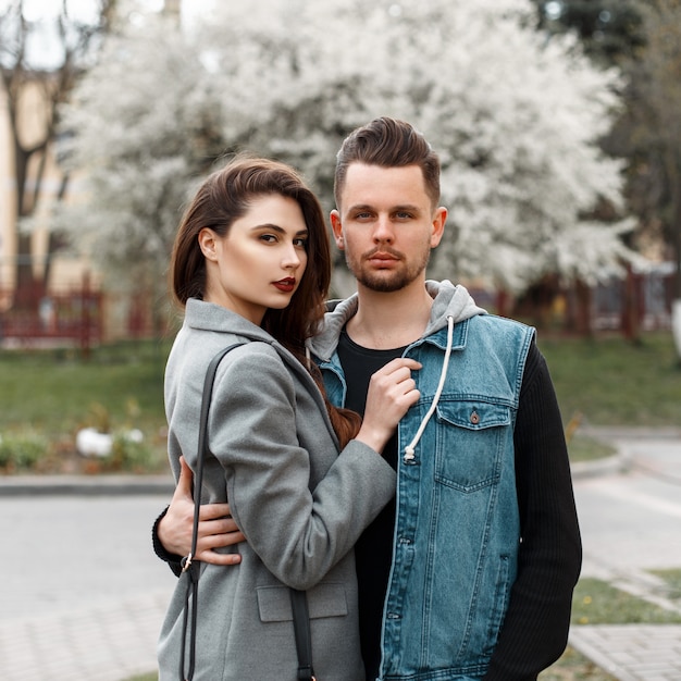 Beautiful stylish young couple hugging on the street