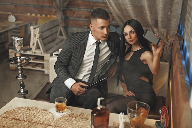 Beautiful stylish young couple relaxing in a bar