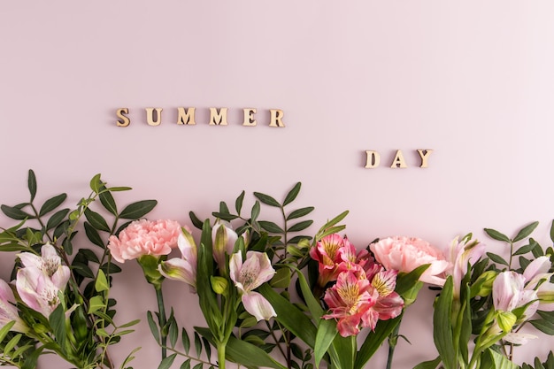 Beautiful summer background with flowers and wooden letters summer day creative composition floral border