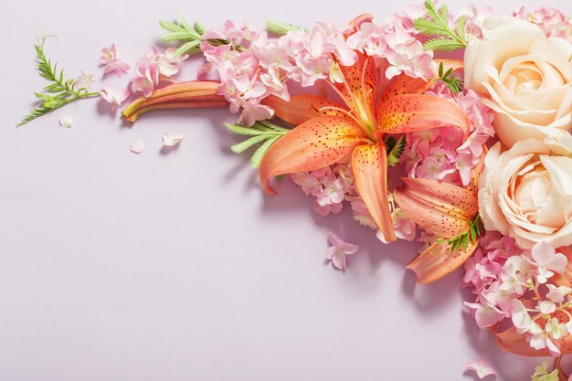 beautiful summer flowers on color paper background