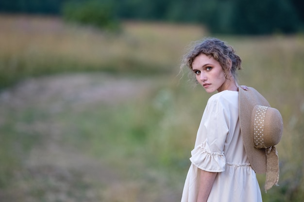 Beautiful summer girl on a wheat field