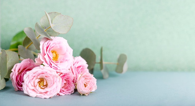 Beautiful summer and spring banner for a website with a bouquet of pink roses and eucalyptus on the