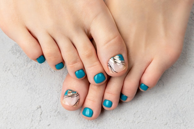 Beautiful summer turquoise nail design. Manicure, pedicure beauty salon concept.