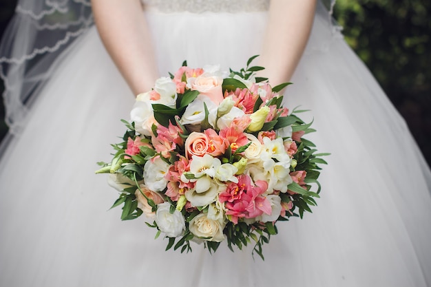 Beautiful summer wedding bouquet and wedding dress