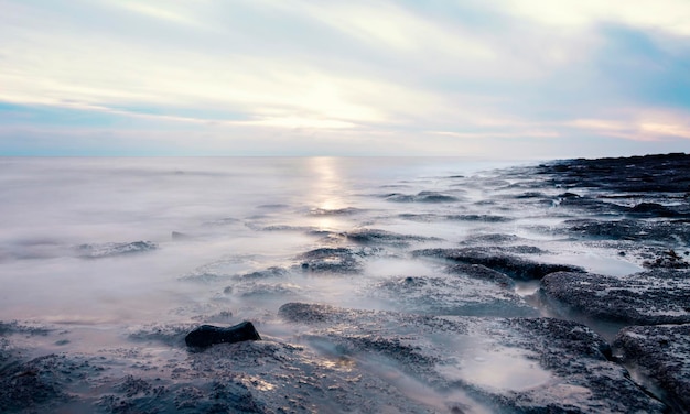 Beautiful sun rise over the rocky coast in winter