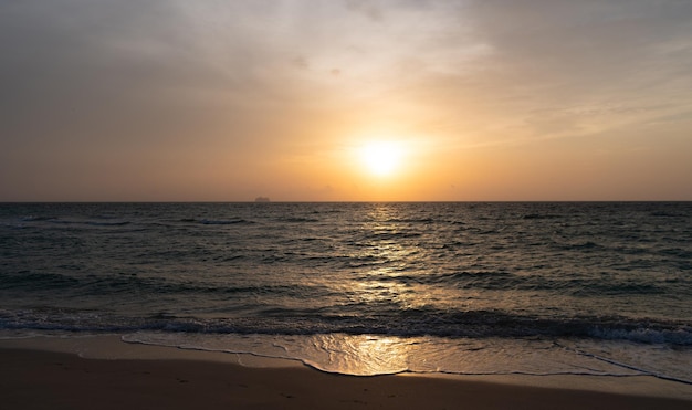 Beautiful sundown sky with waves on sea water