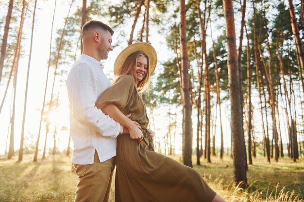 Beautiful sunlight Happy couple is outdoors in the forest at daytime