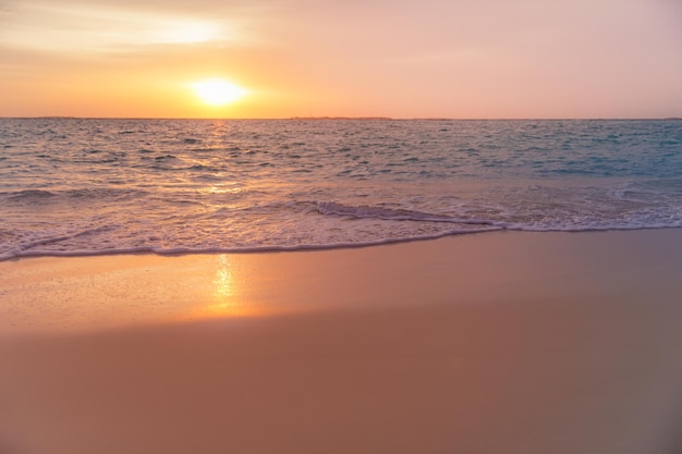 Beautiful sunrise beach. Exotic dramatic shore waves on sand, sea surface. Closeup coastline