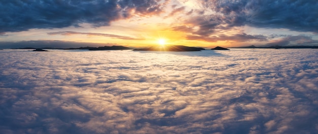 Beautiful sunrise above the clouds in mountains