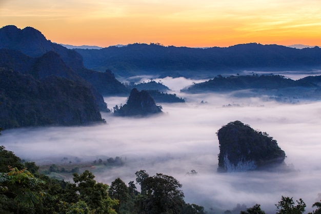 Beautiful Sunrise of travel place with morning mist 