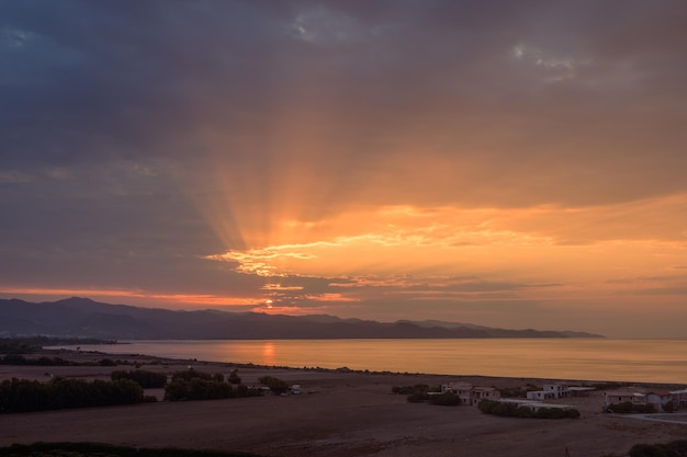 beautiful sunset against the backdrop of the sea and mountains on the island of Cyprus