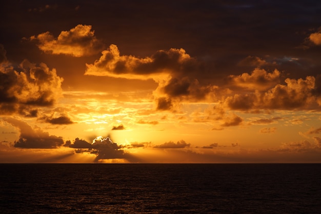 Beautiful sunset in atlantic ocean with amazing clouds recording from the moving ship