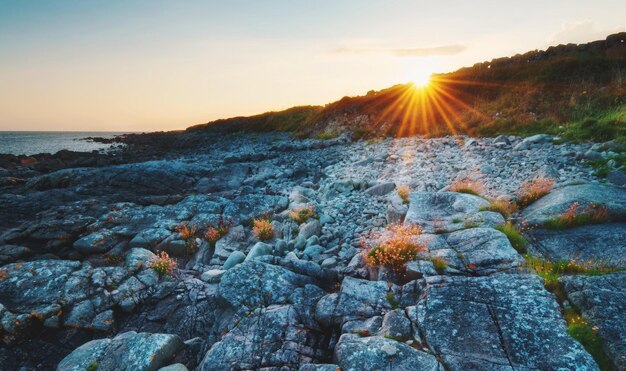 Beautiful sunset beach scape scenery of rocky coast at wild atlantic way in barna galway ireland