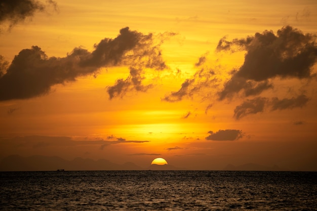 Beautiful sunset over calm sea water. Summer vacation concept. Island Koh Phangan, Thailand