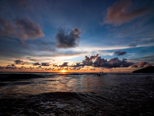 Beautiful sunset over the calm sea with cloud sky background Sunset over tropical beach